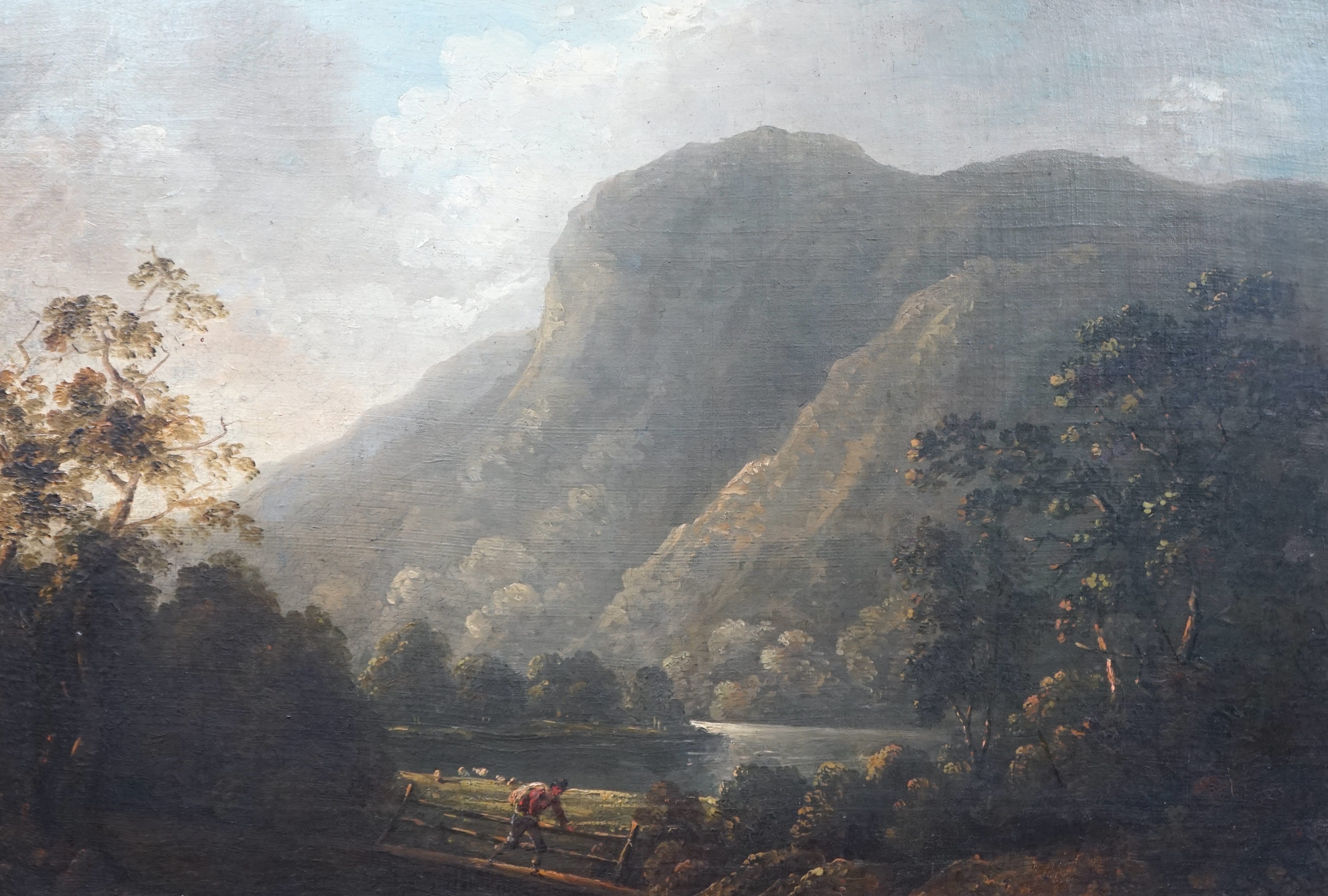 Attributed to Richard Wilson (English, 1714-1782), Mountainous scene with lake, tree and figures crossing a bridge, oil on canvas, 41 x 58cm